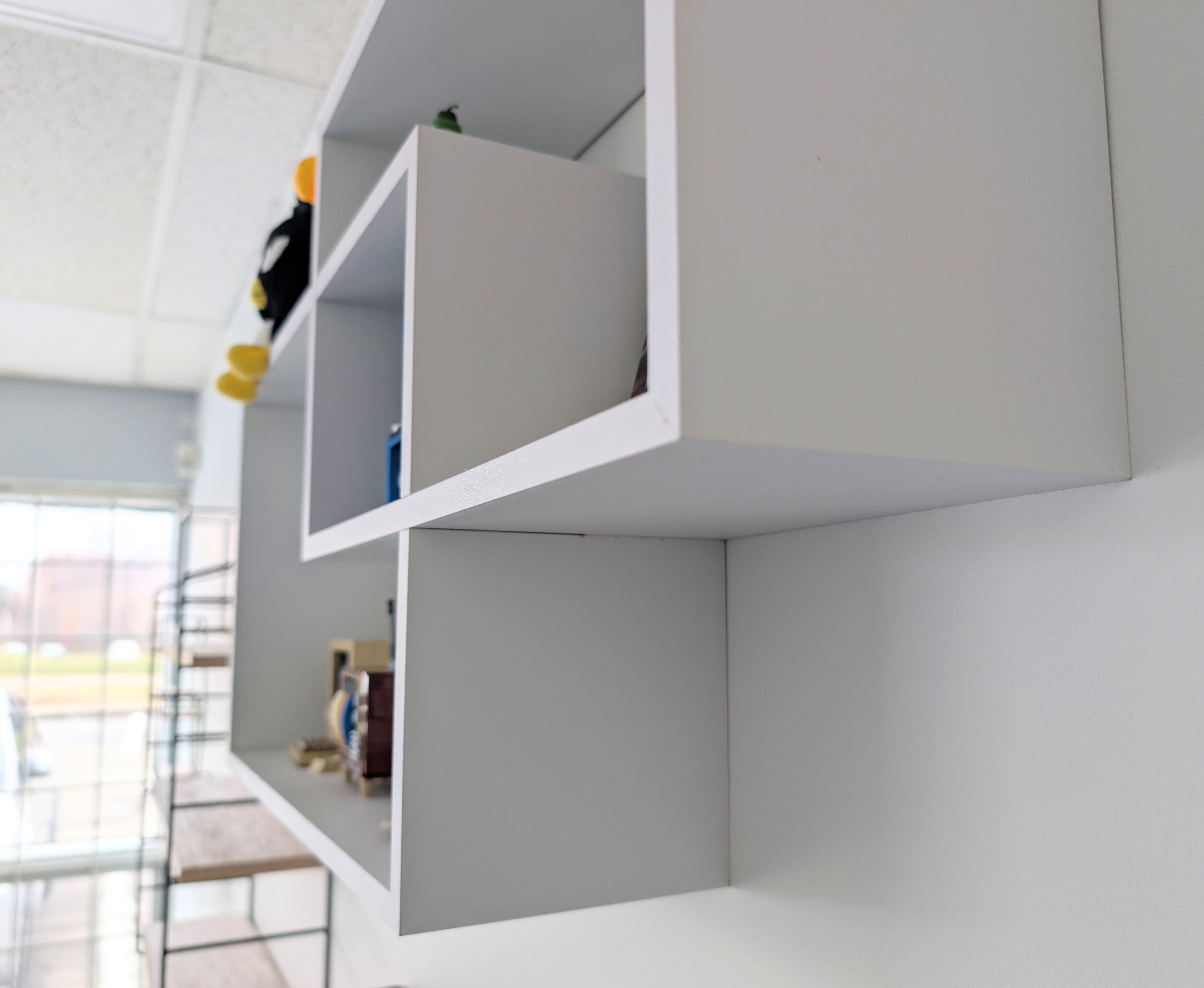 Gray wall-mounted shelves in a modern interior setting