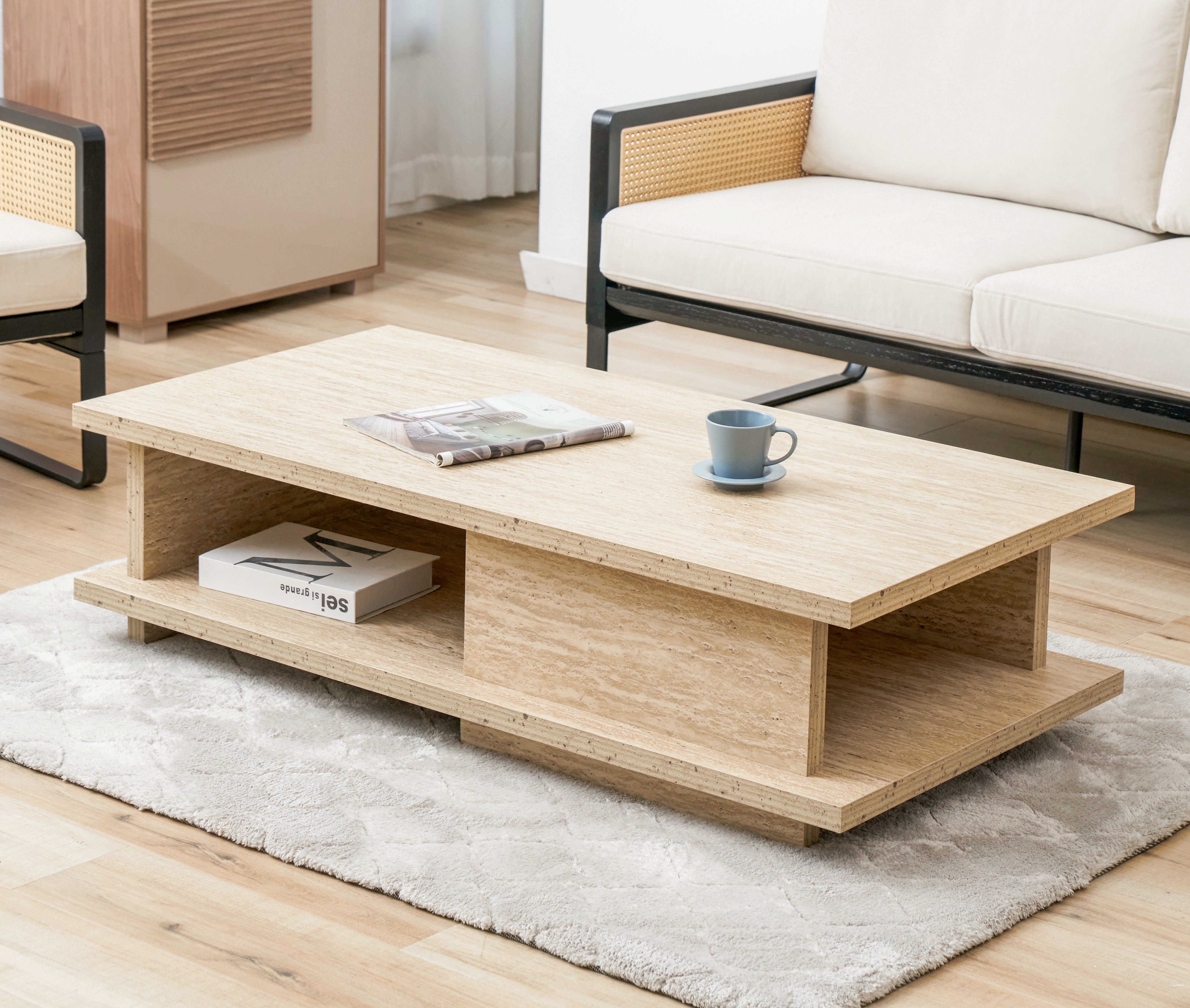 Wooden coffee table in a living room with a couch and rug.