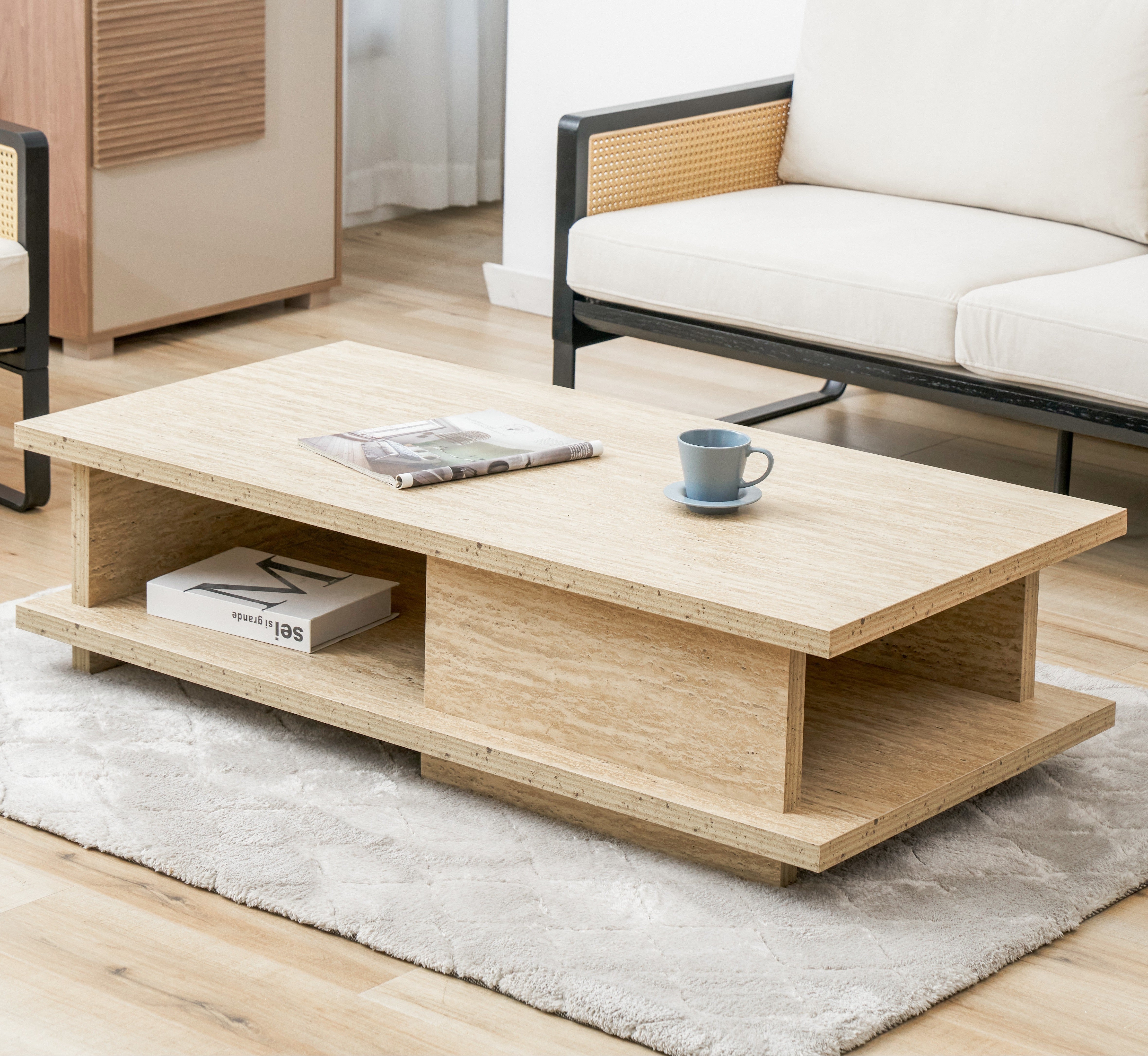 Wooden coffee table in a living room with a couch and rug.