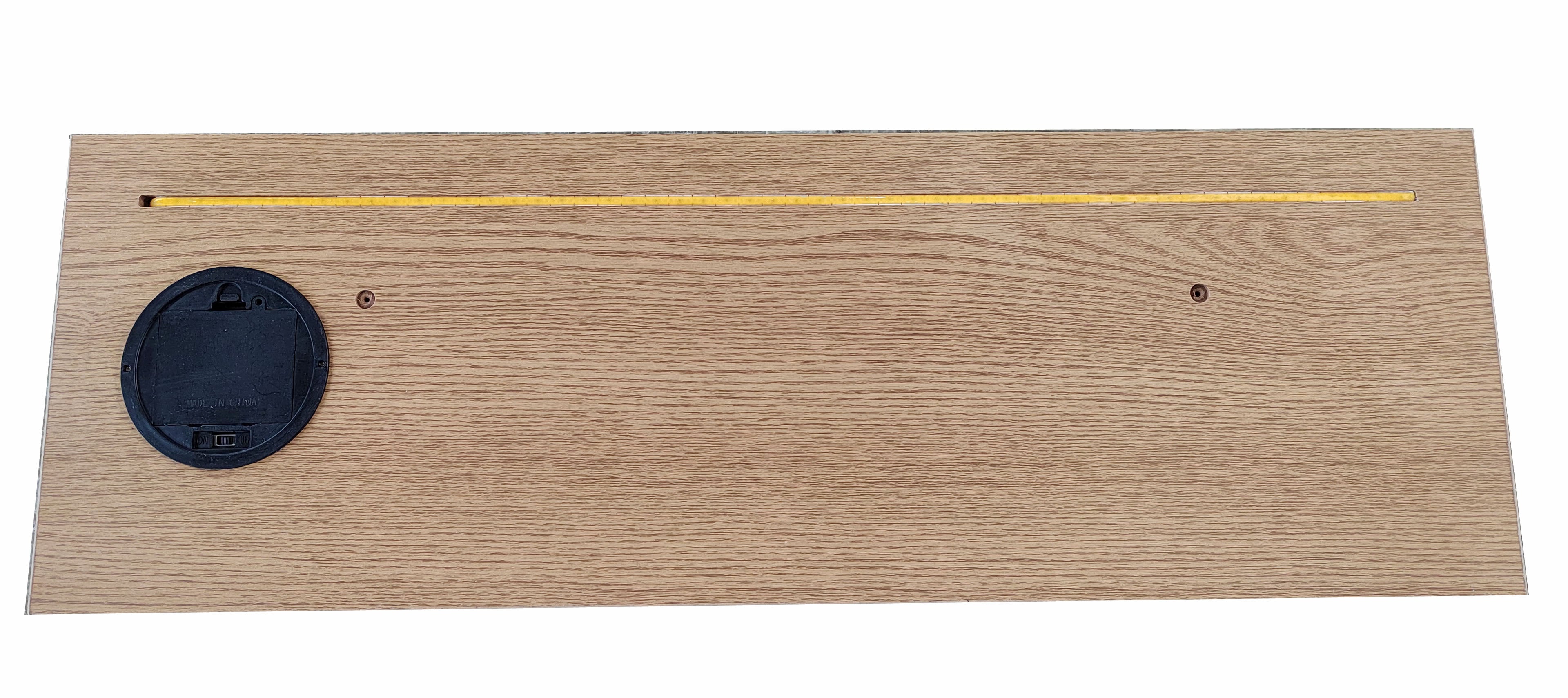 Wooden plaque with a black round object on a white background