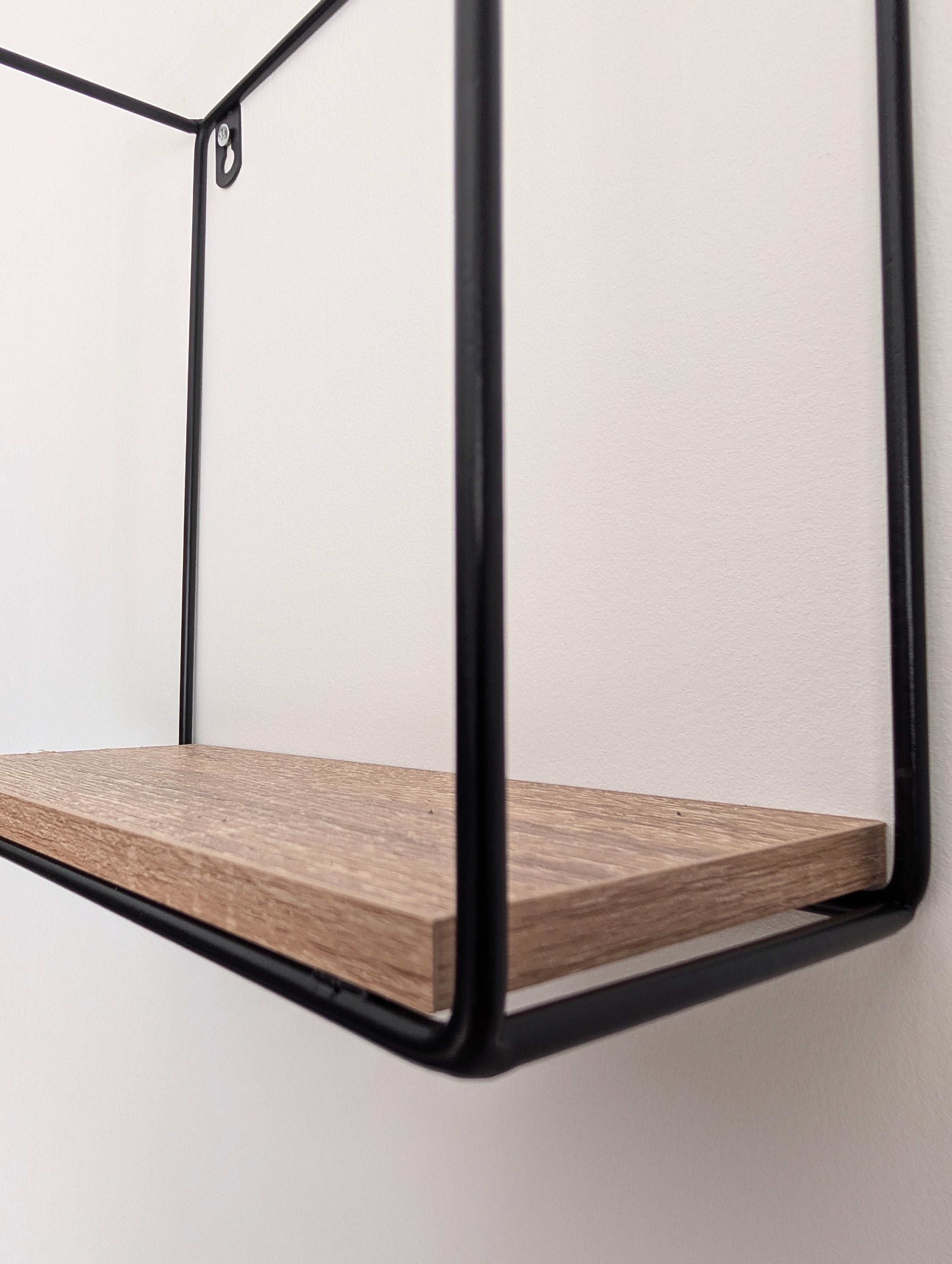 Wooden shelf with black metal frame on a white background