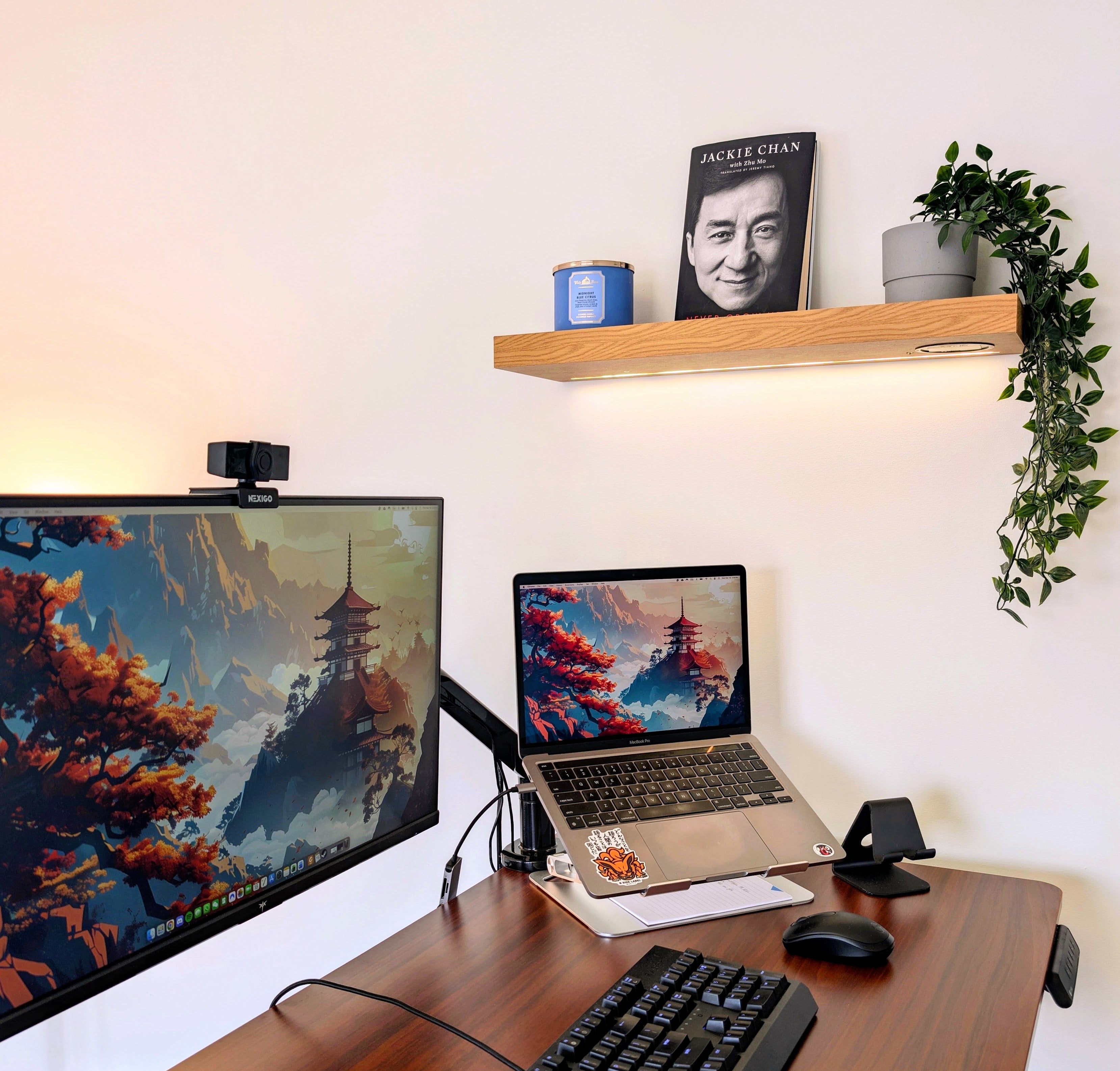 Home office setup with dual monitors, laptop, keyboard, and mouse on a wooden desk.