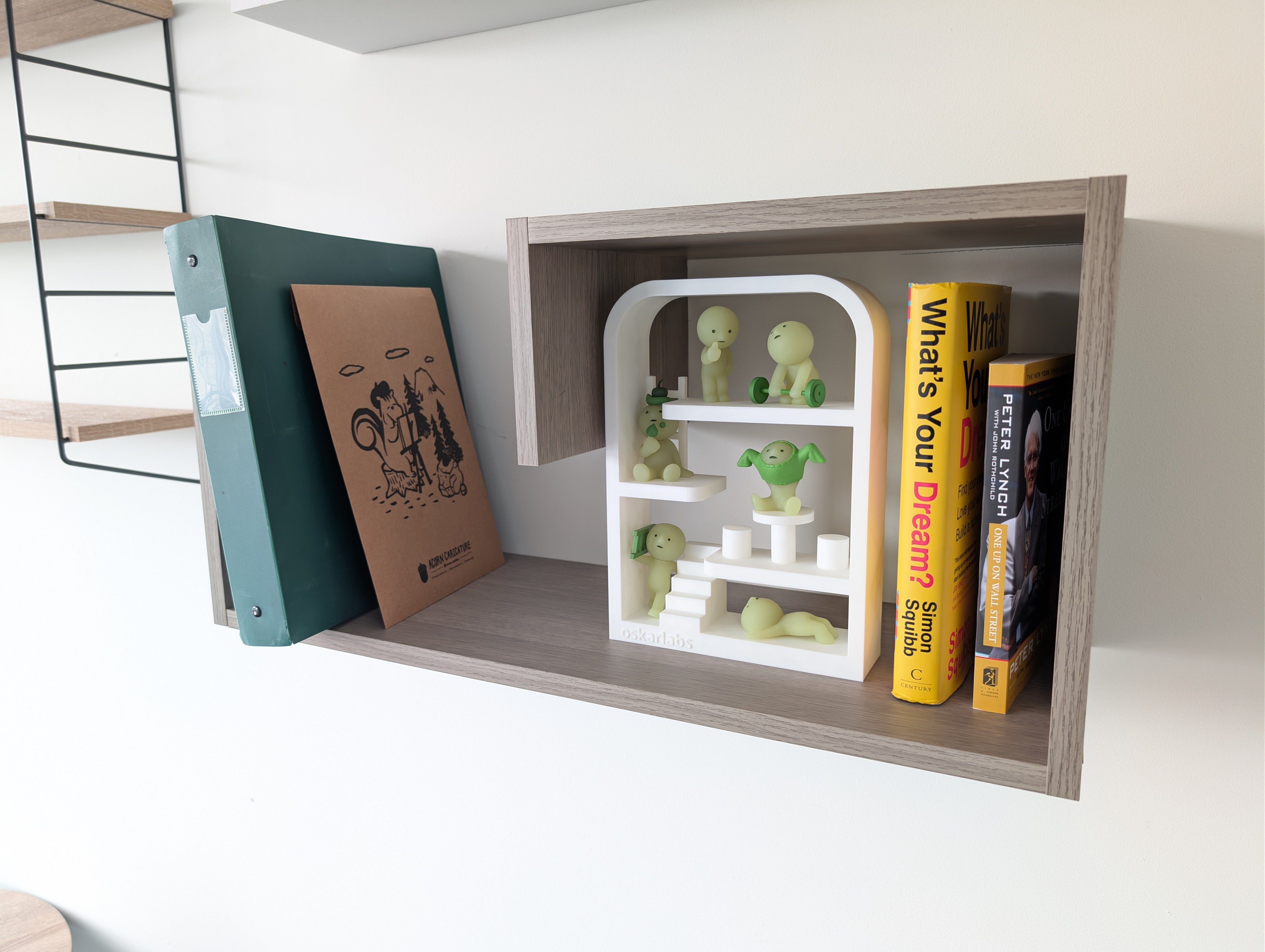 Wooden shelf with books and decorative items on a white surface