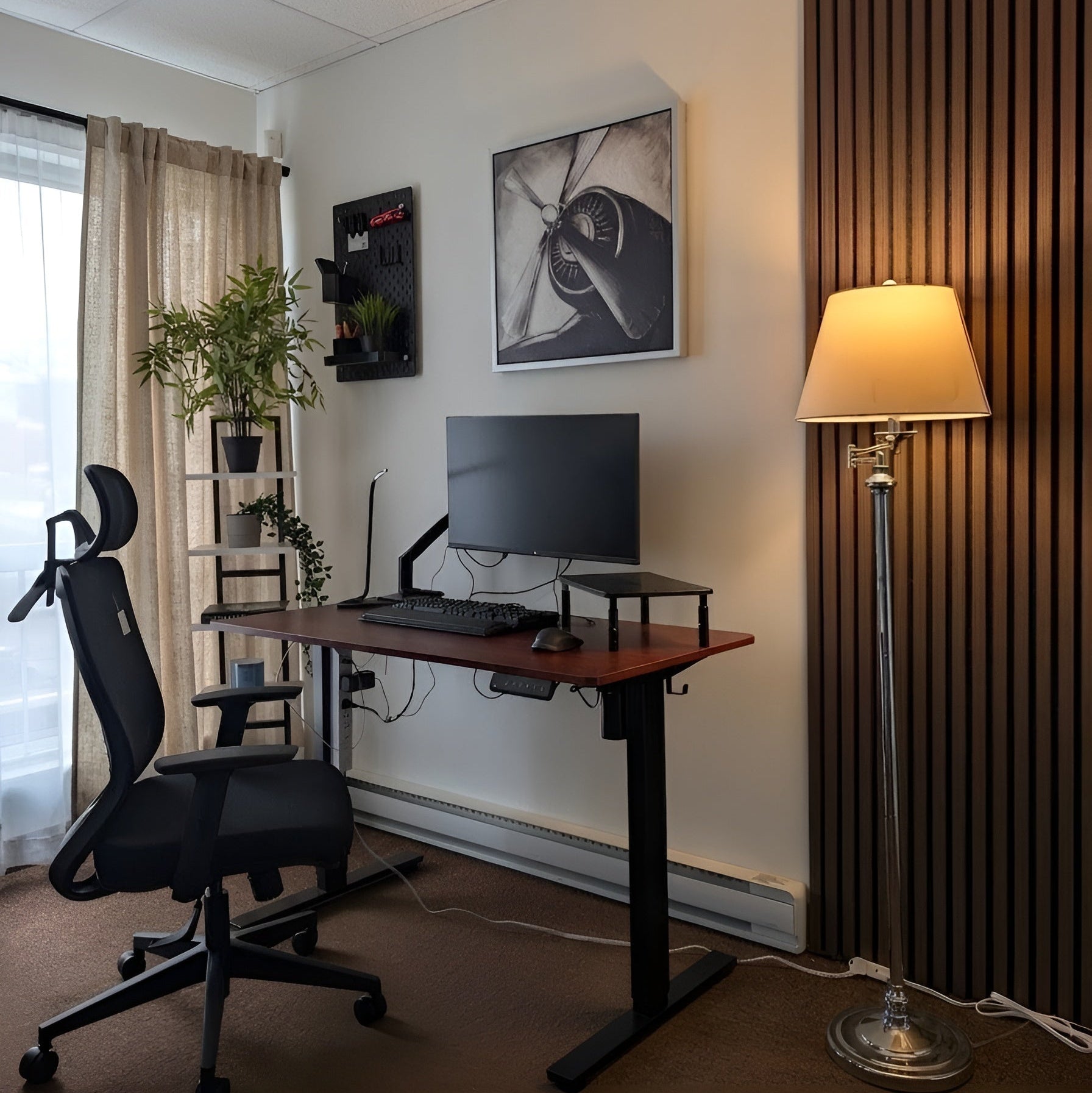 Home office setup with a desk, chair, computer monitor, and lamp.