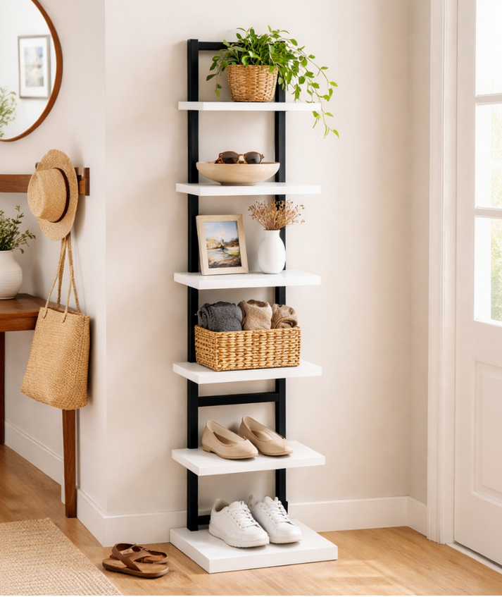 Tall black and white shoe rack with various items on shelves in a room.